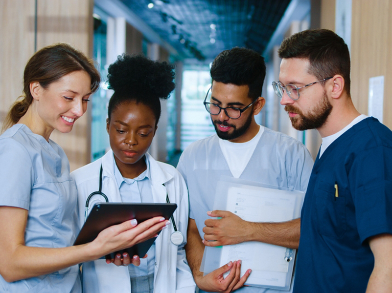 Multicultural,Group,Of,Youthful,Medical,Personnel,Communicating,In,Modern,Hospital